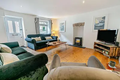 a living room with a couch and a tv and a fireplace at 5 Bed in Padstow oc-s29853 in Padstow