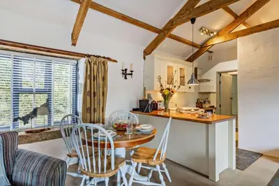a kitchen and dining room with a table and chairs at Cobble by Together Travel - Luxury Cornish Countryside Retreat in Bodmin