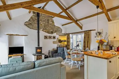 a living room with a couch and a table in a room at Cobble by Together Travel - Luxury Cornish Countryside Retreat in Bodmin