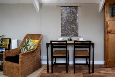 a table and two chairs in a room at Zen Den Cornwall in Boscastle