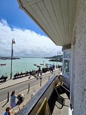 a balcony of a building with a view of the beach at Premier 4 - Stunning Suite, beautiful sea views in St Ives