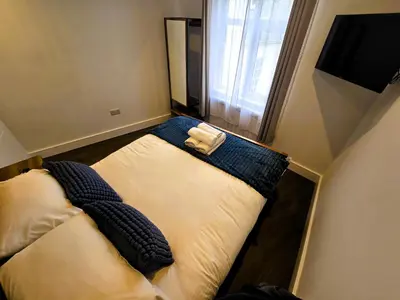 a small bedroom with two beds in a room at Premier 4 - Stunning Suite, beautiful sea views in St Ives