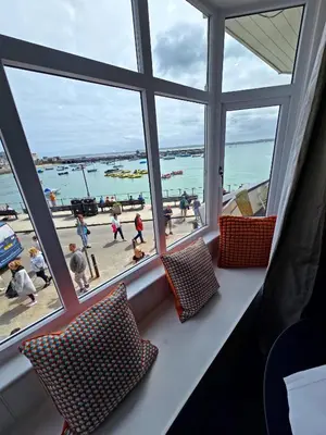 a room with a window with a view of the beach at Premier 4 - Stunning Suite, beautiful sea views in St Ives
