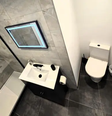 a bathroom with a sink and a toilet at Premier 4 - Stunning Suite, beautiful sea views in St Ives