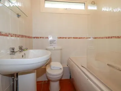 a bathroom with a sink and a toilet and a tub at Constantine Bay in Padstow