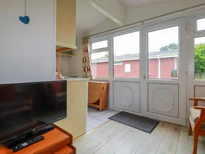 a kitchen with a large sliding glass door at Constantine Bay in Padstow