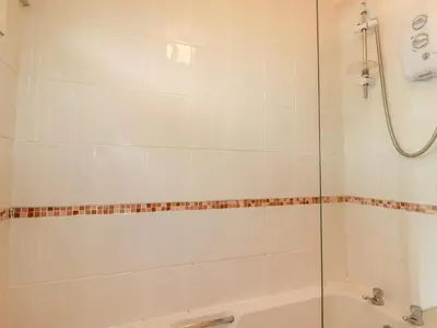 a bathroom with a shower and a bath tub at Constantine Bay in Padstow