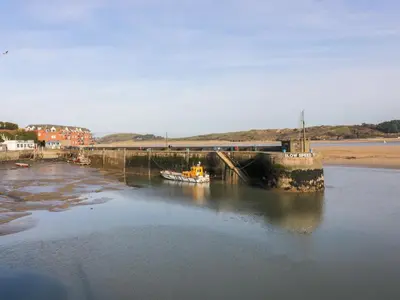 a boat is docked in a body of water at Newtrain Bay in Padstow