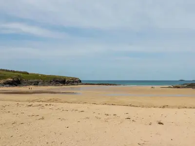 a sandy beach with the ocean in the background at Newtrain Bay in Padstow