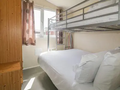 a bedroom with two bunk beds and a ladder at Warren Cove in Padstow