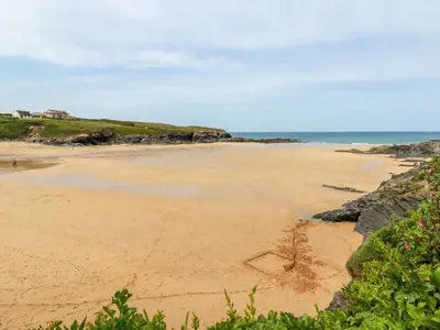 a beach with a heart drawn in the sand at Hawker's Cove in Padstow