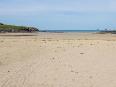 a sandy beach with the ocean in the background at High Cove in Padstow