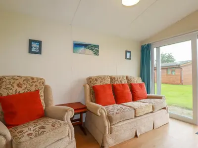 a living room with two chairs and a couch at Fox Cove in Padstow