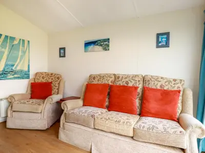 a living room with two chairs and a couch at Fox Cove in Padstow