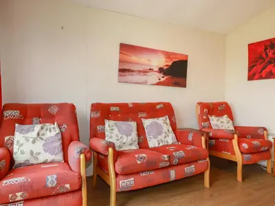 a living room with two chairs and a couch at Pepper Cove in Padstow
