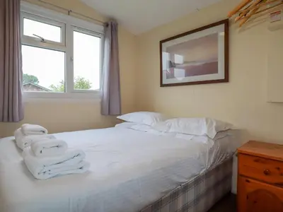 a bedroom with a bed with towels on it at Pepper Cove in Padstow