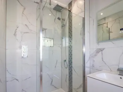 a bathroom with a shower and a sink at Carnon Gwel, Devoran in Truro