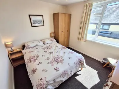 a bedroom with a bed and a window at Loe Bar Bottom in Porthleven