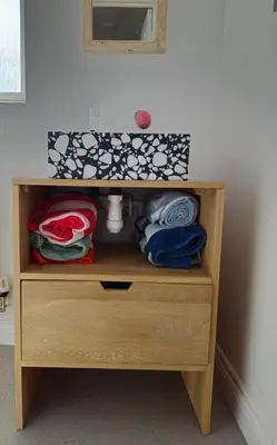 a wooden dresser with towels on top of it at Cosy house on a quiet estate in Truro in Truro