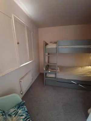 a bedroom with two bunk beds and a window at Cosy house on a quiet estate in Truro in Truro