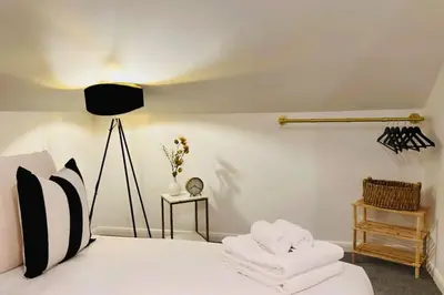 a bedroom with a bed with two towels on it at St Mary's Mews in Truro