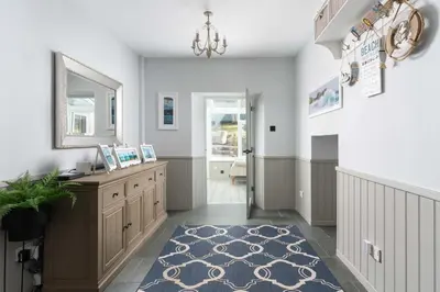 a home office with a desk and a rug at Beautiful Country Farmhouse Set In A Stunning Woodland With Pool, Sauna & Parking at 'The Old Farmhouse' in Ponsanooth