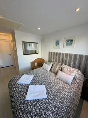 a bedroom with a bed with two towels on it at Cosy 1 bed apartment near Crantock beach in Crantock