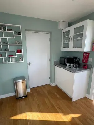 a kitchen with a counter and a white door at Cosy 1 bed apartment near Crantock beach in Crantock