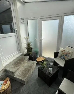 a living room with a couch and a window at Cosy 1 bed apartment near Crantock beach in Crantock