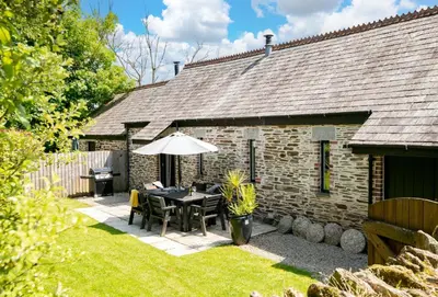 a patio with a table and an umbrella at Hob Nob in Liskeard