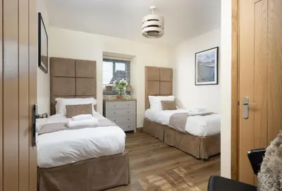 a bedroom with two beds and a window at Hob Nob in Liskeard