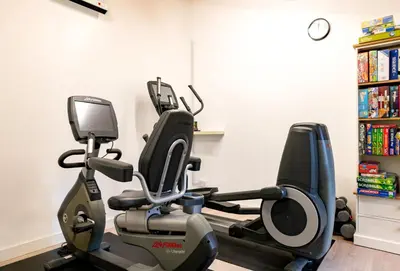 a gym with a exercise bike in a room at Rainbow Cottage in Liskeard
