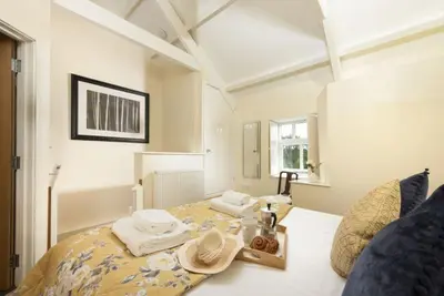 a bedroom with a bed with a tray of food on it at Honey Pot in Liskeard