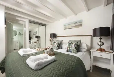 a bedroom with a bed with two towels on it at Spice Barn in Liskeard