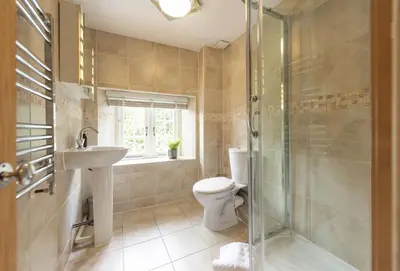 a bathroom with a toilet and a sink and a shower at The Old Farmhouse in Liskeard