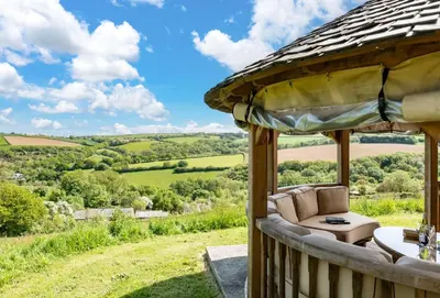 a gazebo with a view of the rolling hills at The Old Farmhouse in Liskeard