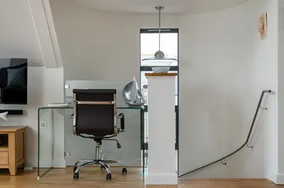an office with a glass desk and a chair at Atlantic View Coach House, North Cornwall seafront, 5 star Gold in Polzeath