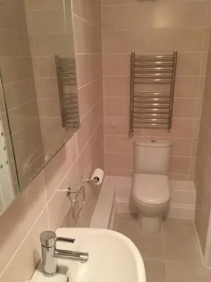 a bathroom with a toilet and a sink at Cosy Traditional Cornish Cottage in Tregoney