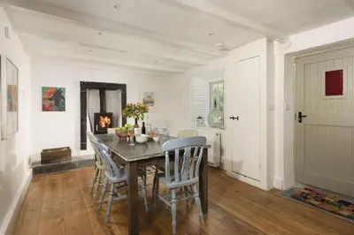 a dining room with a table and chairs at Worvas Counthouse - Country Cottage - Hot Tub - Pet Friendly in St Ives
