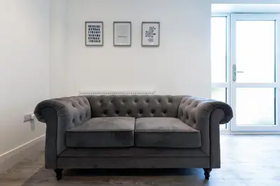 a couch in a room with a white wall at Another Nook in St Ives