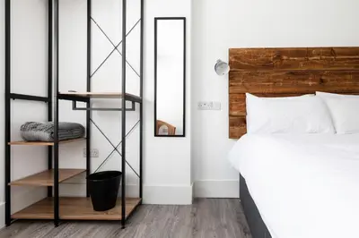 a bedroom with a bed and a mirror at Another Nook in St Ives
