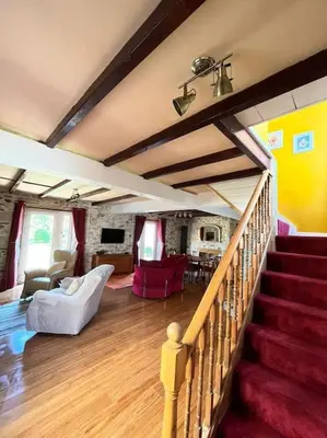 a large living room with a staircase and a living room at Open Plan 3 Bedrooms Cornish stone house cottage in St Austell