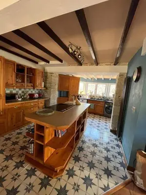 a kitchen with a island in the middle of a room at Open Plan 3 Bedrooms Cornish stone house cottage in St Austell