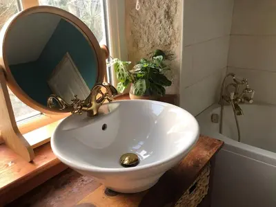 a bathroom with a sink with a mirror and a tub at Open Plan 3 Bedrooms Cornish stone house cottage in St Austell