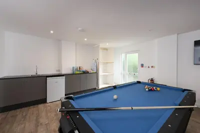 a pool table in the middle of a room at Tre Lowen, Goonhavern, Perranporth - Free Parking - Free Wifi - Games Room in Perranporth