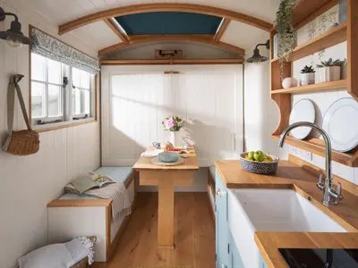 a small kitchen with a sink and a table at Stargazer in Truro