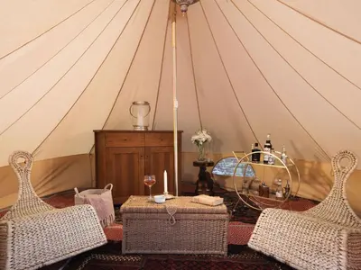 a room with a tent with a table and two chairs at Stargazer in Truro