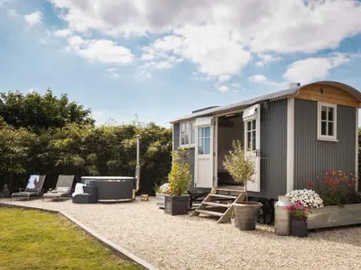 a tiny house with a hot tub in a yard at Stargazer in Truro
