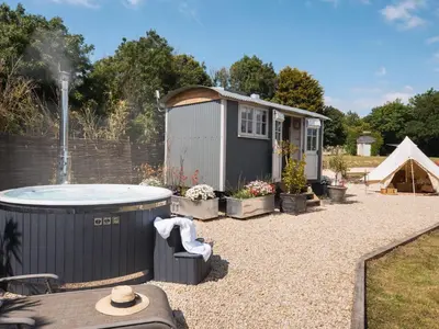 a small shed with a hot tub in a yard at Stargazer in Truro