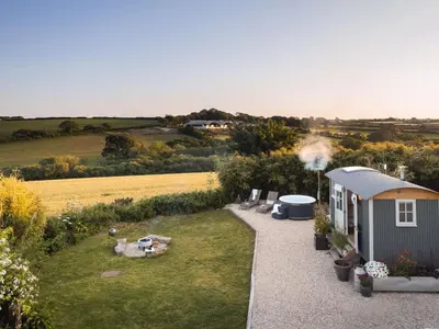 a tiny house with a grill next to a field at Stargazer in Truro